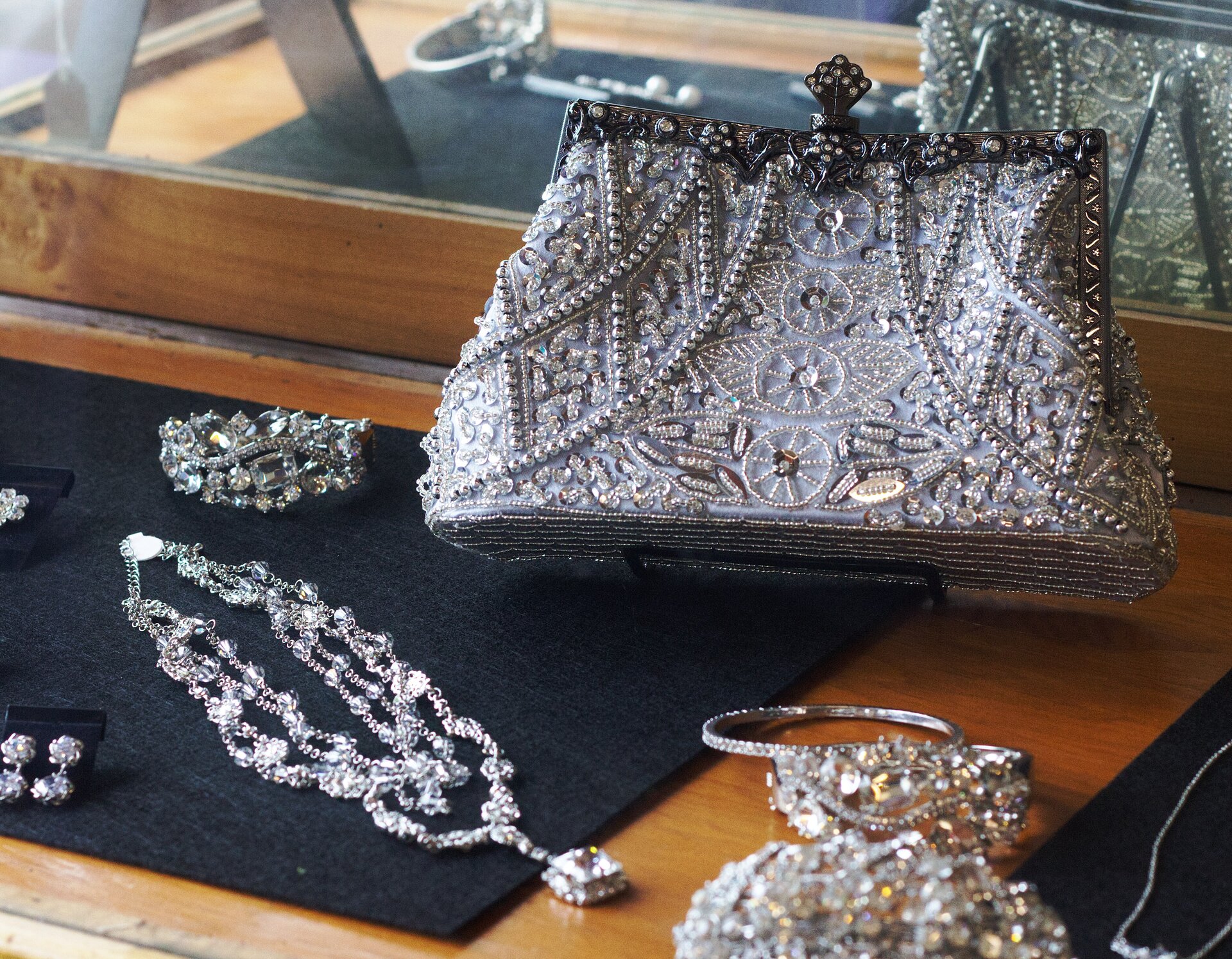 A display of a beaded handbag and jewelry.
