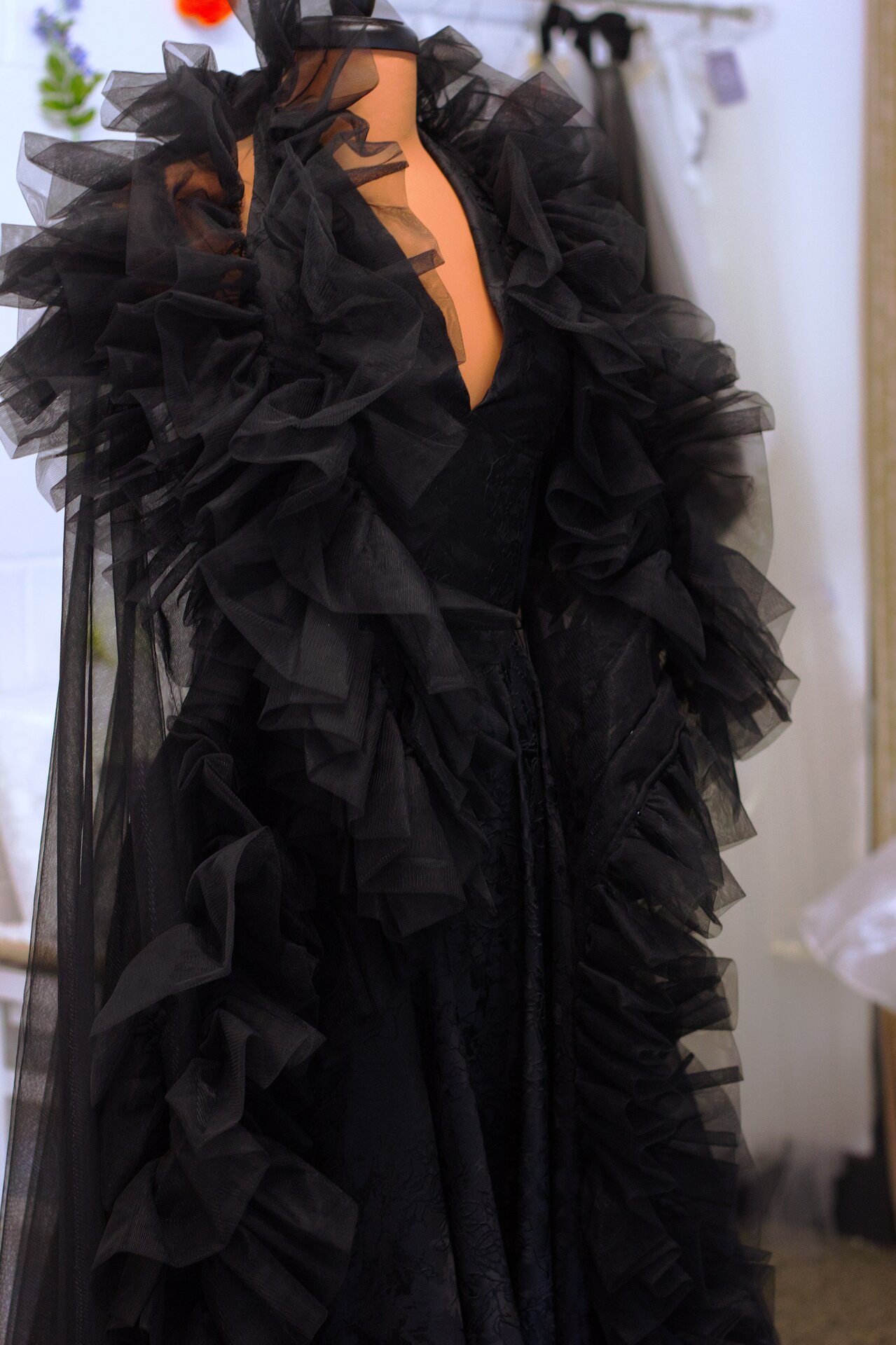 A black dress paired with a black ruffle robe.