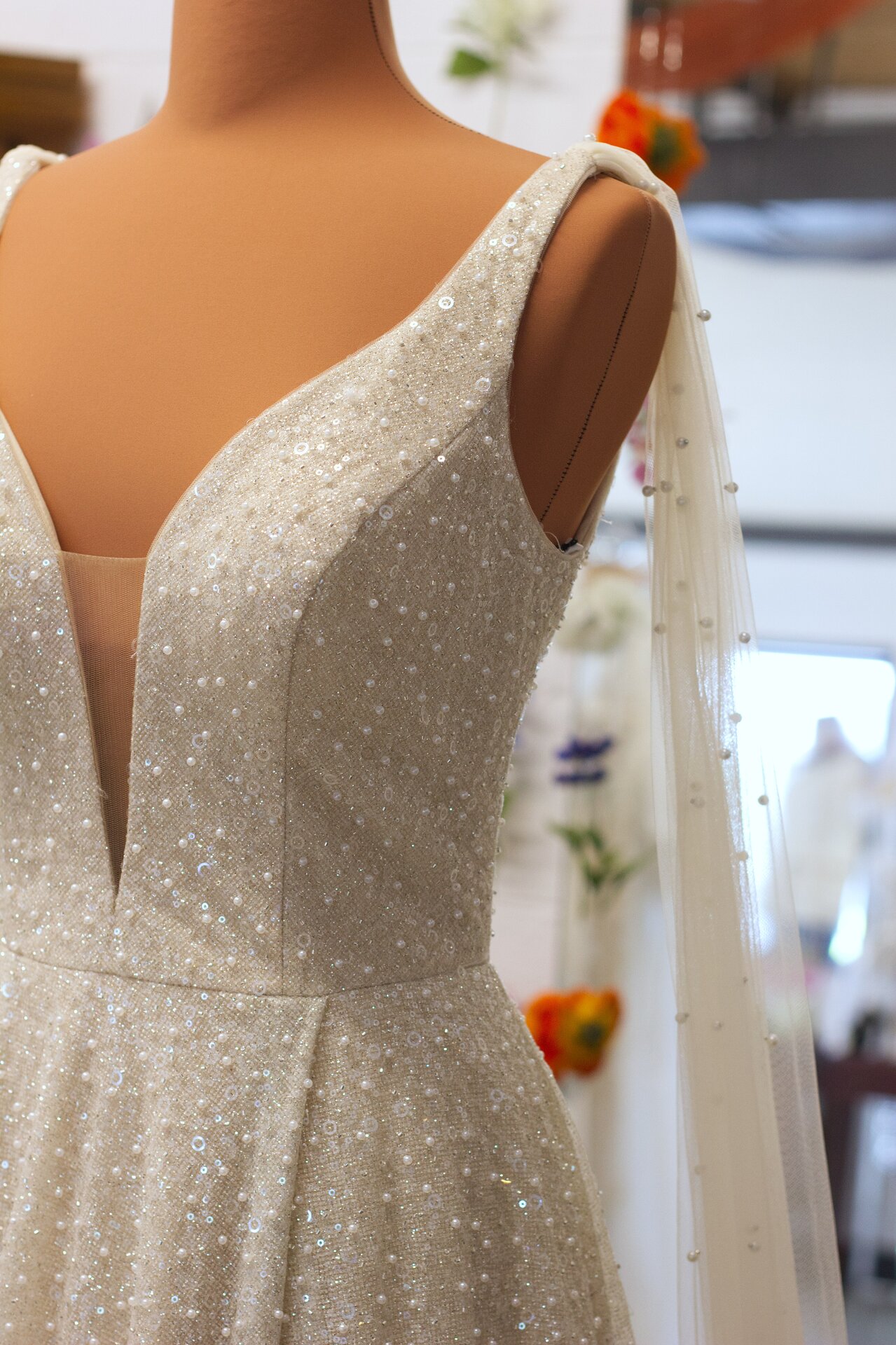 A champagne full beaded a-line wedding gown.