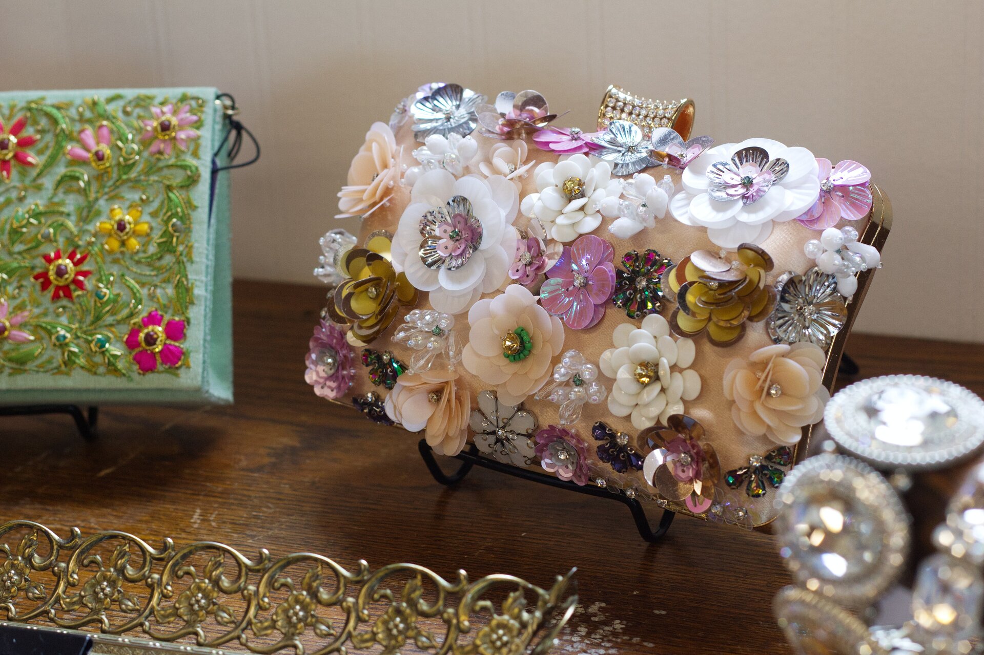A display of floral formal handbags and purses.
